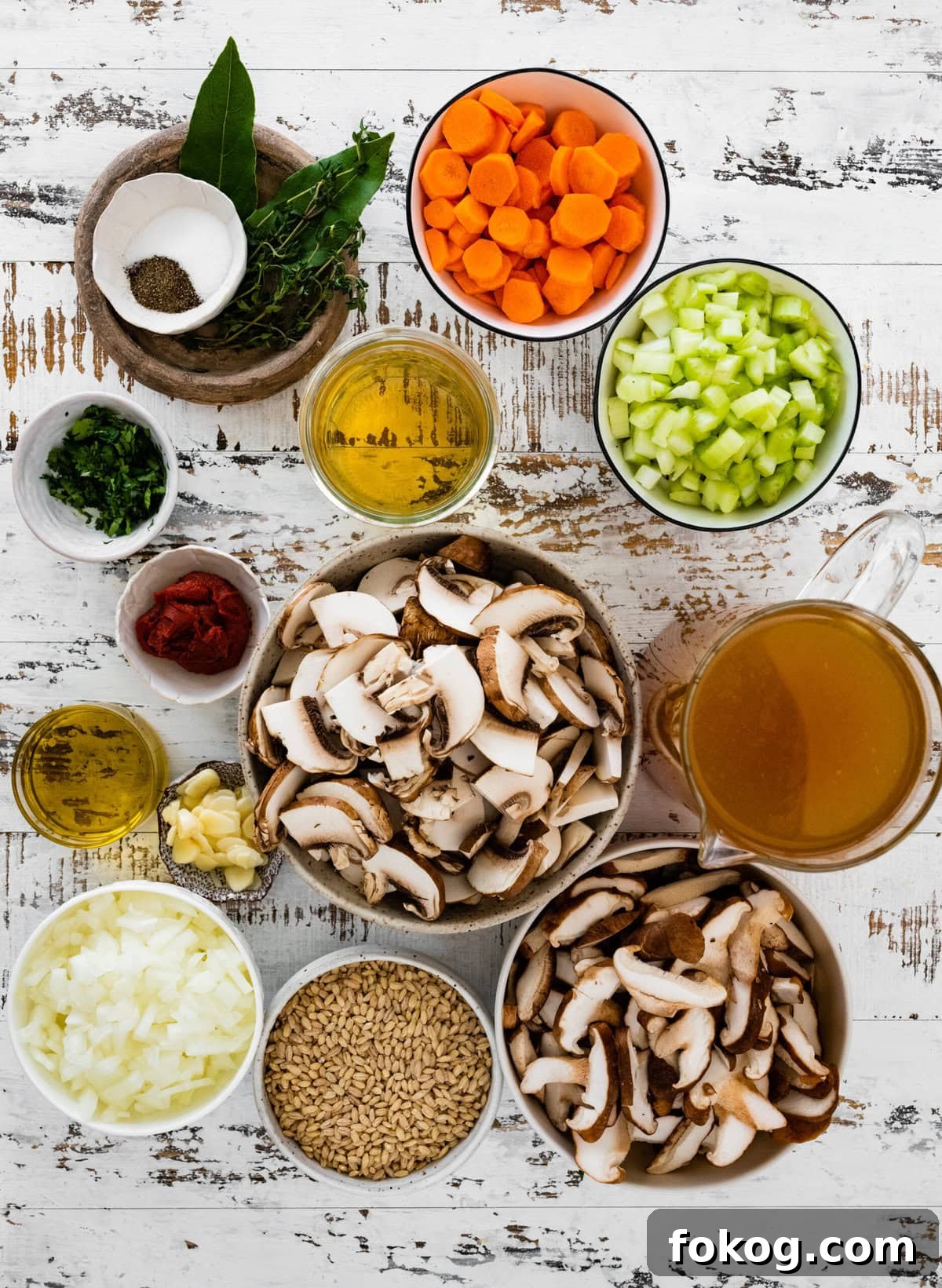 Ingredients for mushroom barley soup including carrots, celery, and onion.