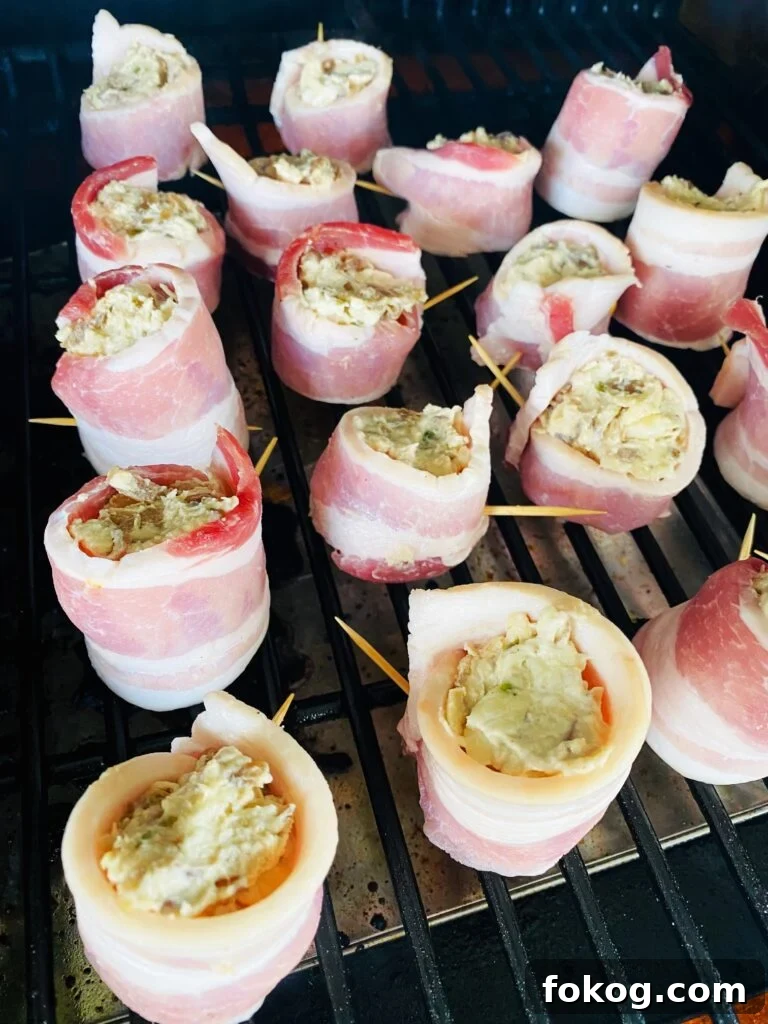 Cheesy Caramelized Onion Bacon-Wrapped Pig Shots: Party Appetizer 6 cheesy caramelized onion pig shots on the smoker before cooking