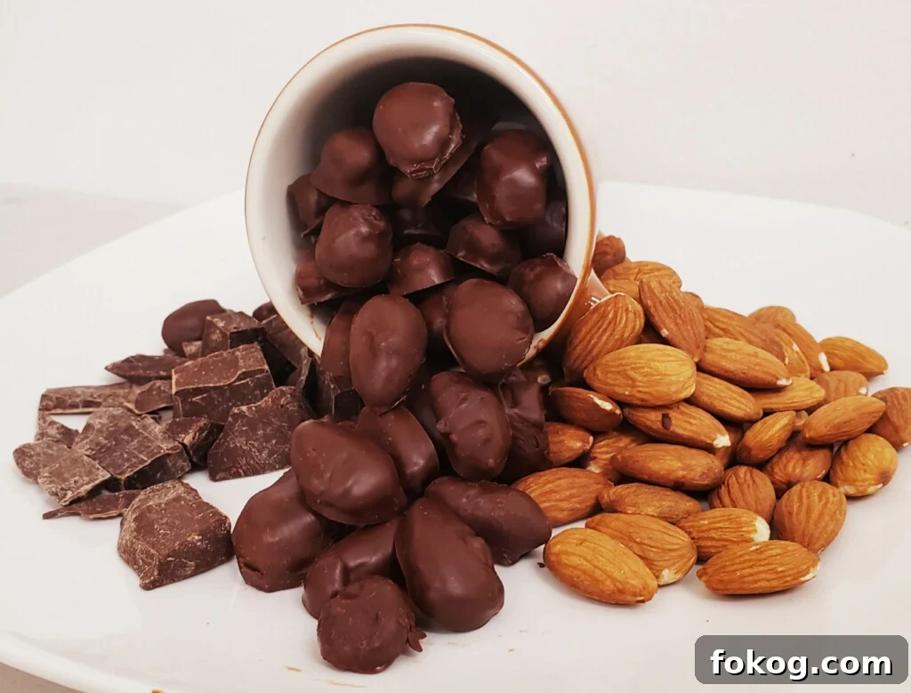 6 Organic Chocolate Brands Low in Heavy Metals 10 glossy chocolate-covered almonds spilling from a cup