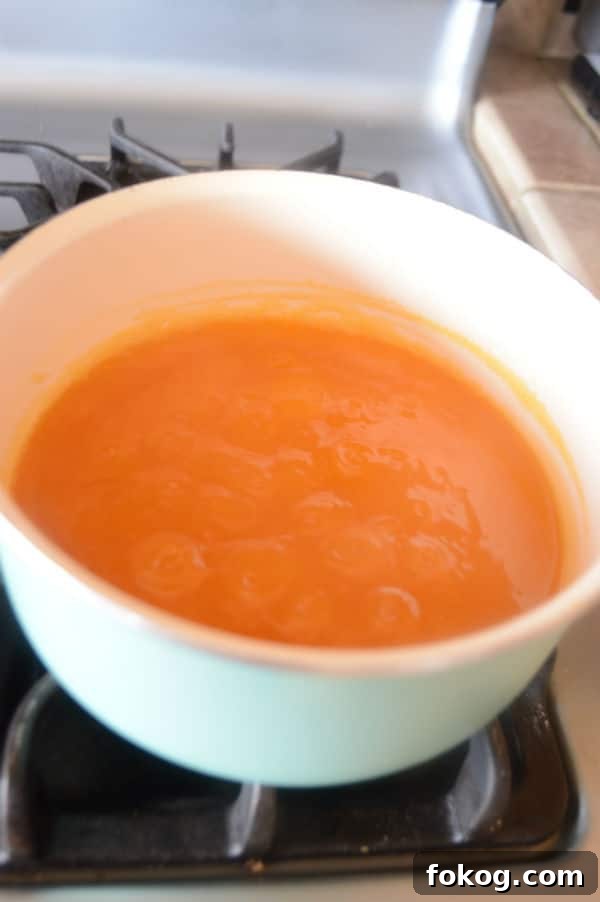 Qamar al-Deen Apricot Pudding Recipe: Traditional Middle Eastern Dessert 7 A pan of Apricot juice on a stove top