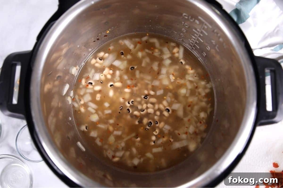 Instant Pot Dried Black Eyed Peas Instant Pot with stock and dried black eyed peas.