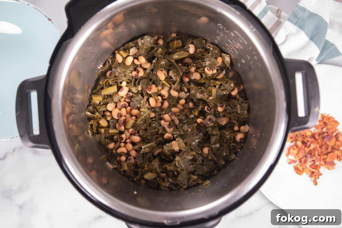 Instant Pot Black Eyed Peas Cooked black eyed peas and greens in inner pot.