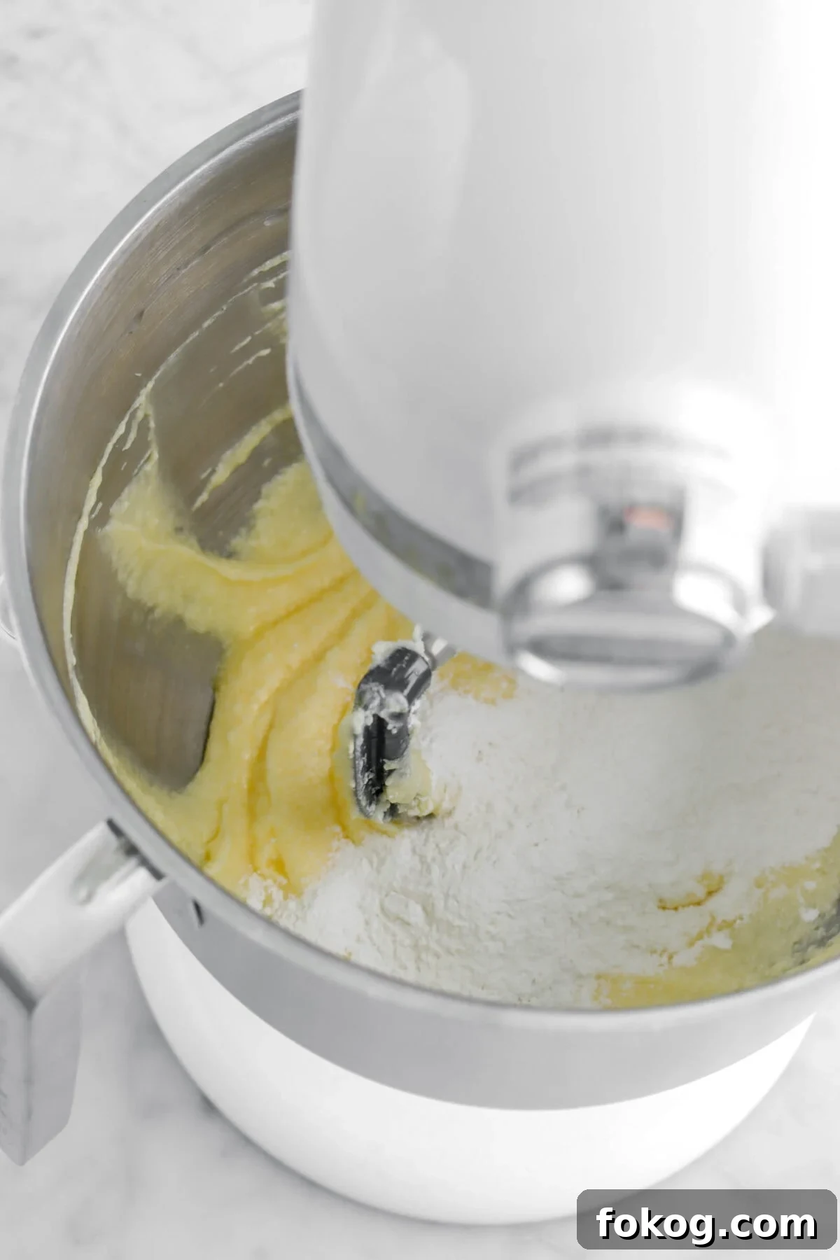 Classic Vanilla Cake with Smooth Buttercream Frosting 11 dry ingredients added to butter mixture.
