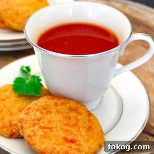 Tomato and Herb Broth Recipe for Flavorful Soups and Stews 5 Tomato drink in china cup on saucer.