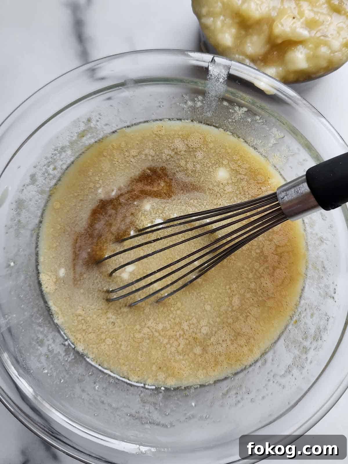 Moist Banana Pecan Muffins Recipe for Breakfast or Brunch 6 Wet ingredients in a bowl for banana muffins.