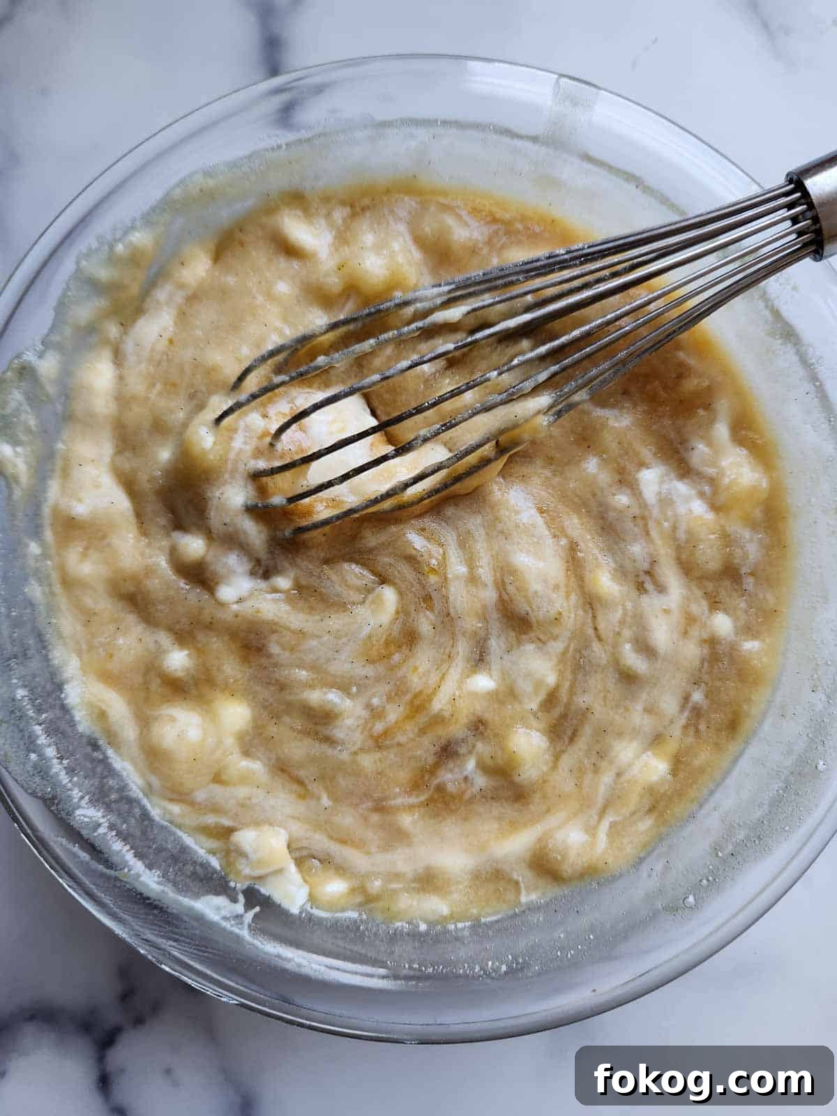 Moist Banana Pecan Muffins Recipe for Breakfast or Brunch 8 Banana muffin batter in a clear bowl.