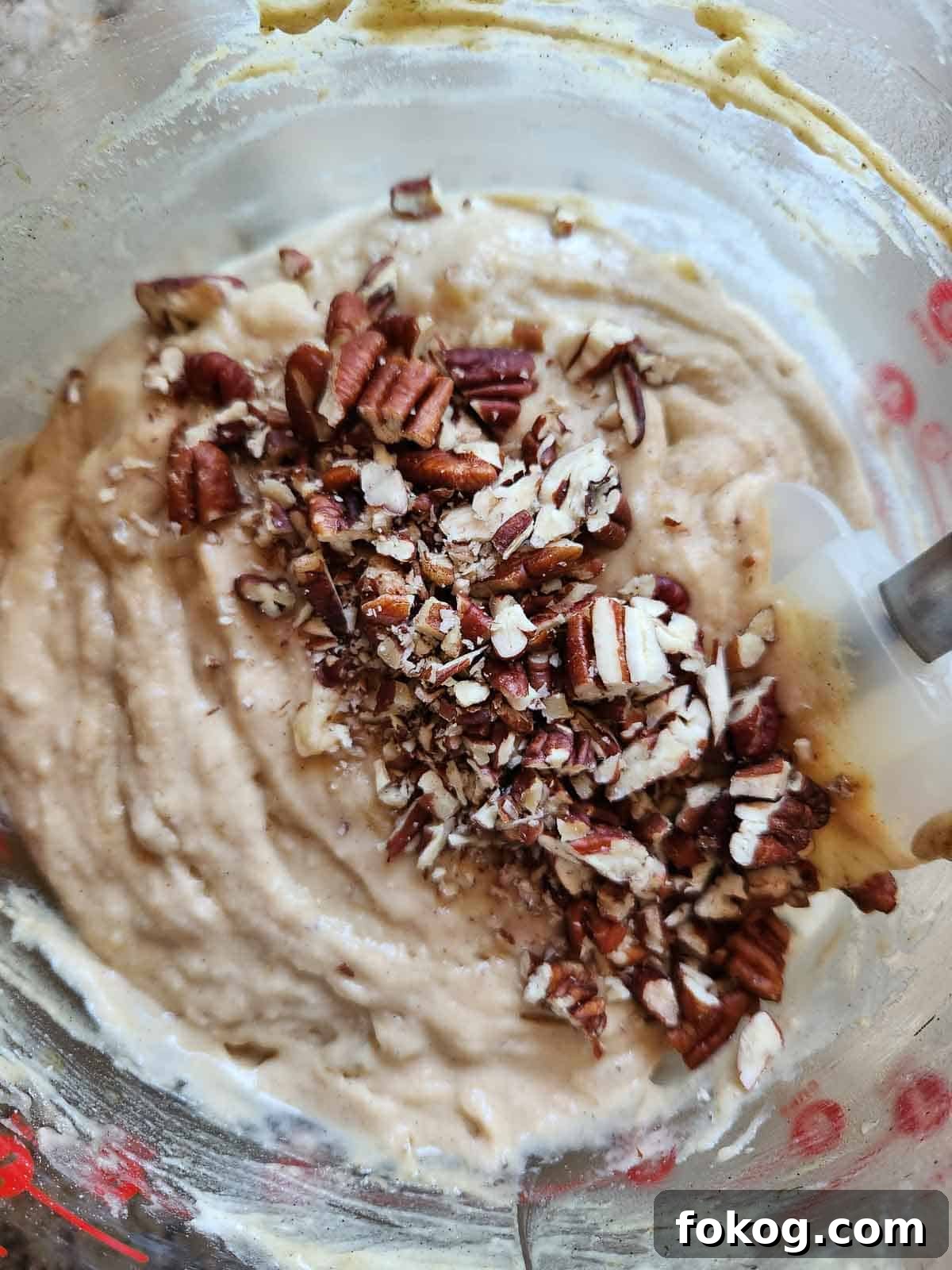Moist Banana Pecan Muffins Recipe for Breakfast or Brunch 9 Banana muffin batter with pecans in a clear bowl.