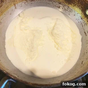 cream and milk powder in a pan