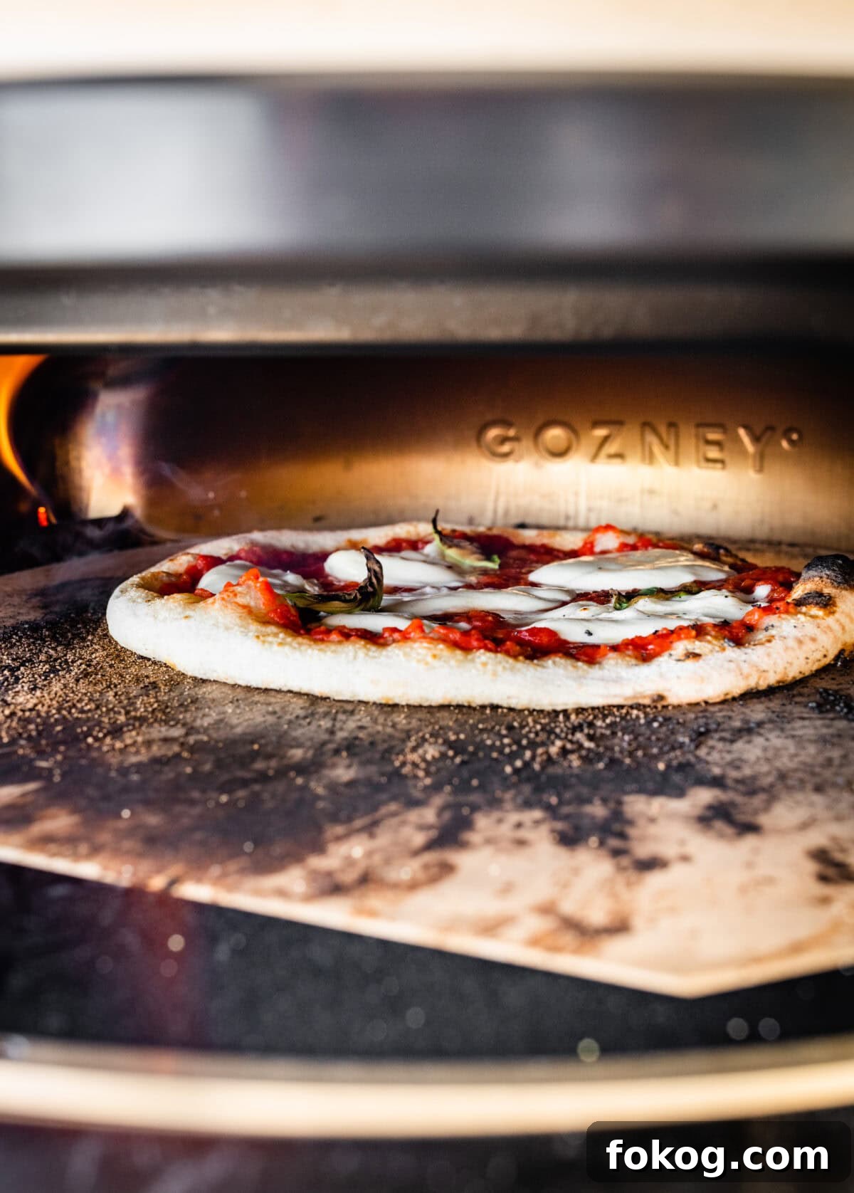 A pizza is being cooked in an oven.