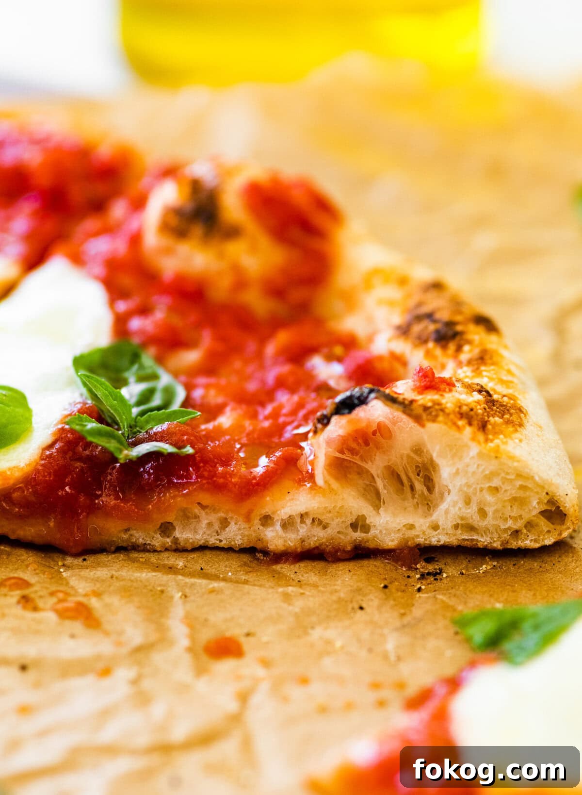 A neapolitan pizza with tomato sauce and basil leaves