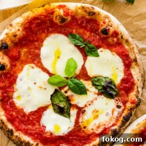 Two pizzas with mozzarella and basil on a wooden table. Neapolitan pizza margherita recipe.