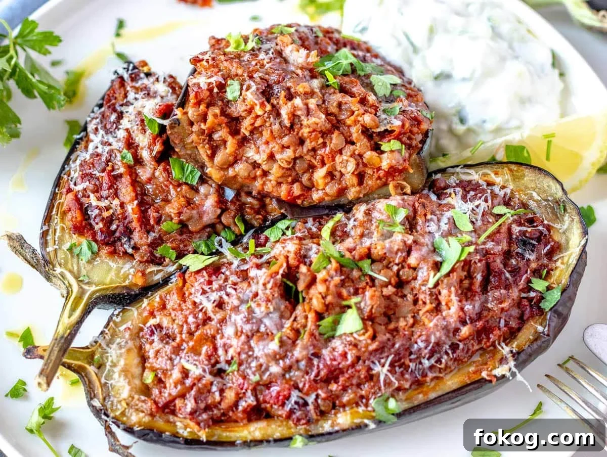 Stuffed eggplant cut in half with fresh parsley