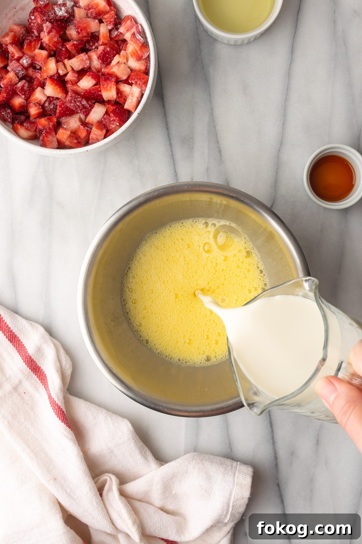 Gluten-Free Strawberry Muffins Recipe with Moist, Tender Crumbs 7 Dairy free milk being poured into whisked eggs.
