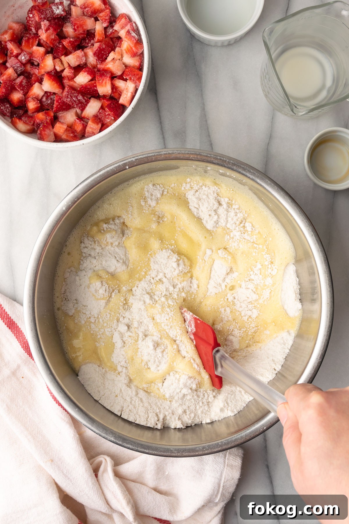 Gluten-Free Strawberry Muffins Recipe with Moist, Tender Crumbs 8 Muffin batter being mixed together by hand.
