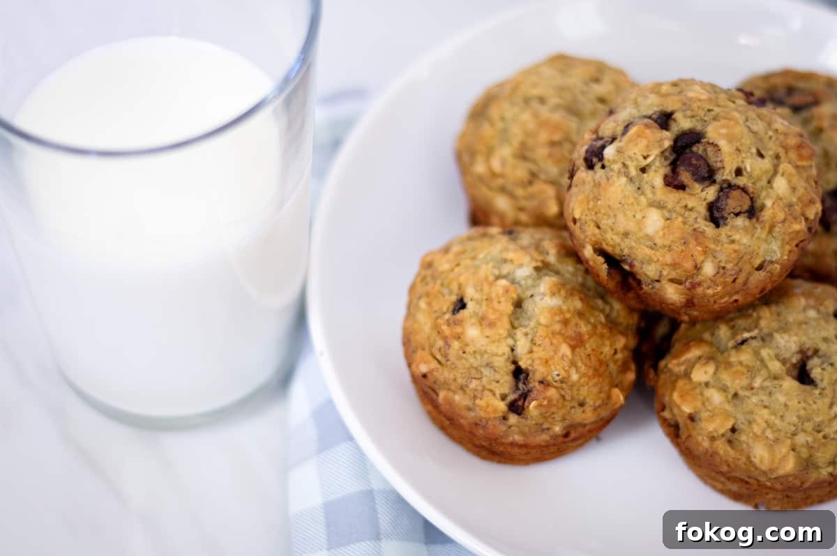 A plate with sourdough banana oat muffins and glass of milk. 