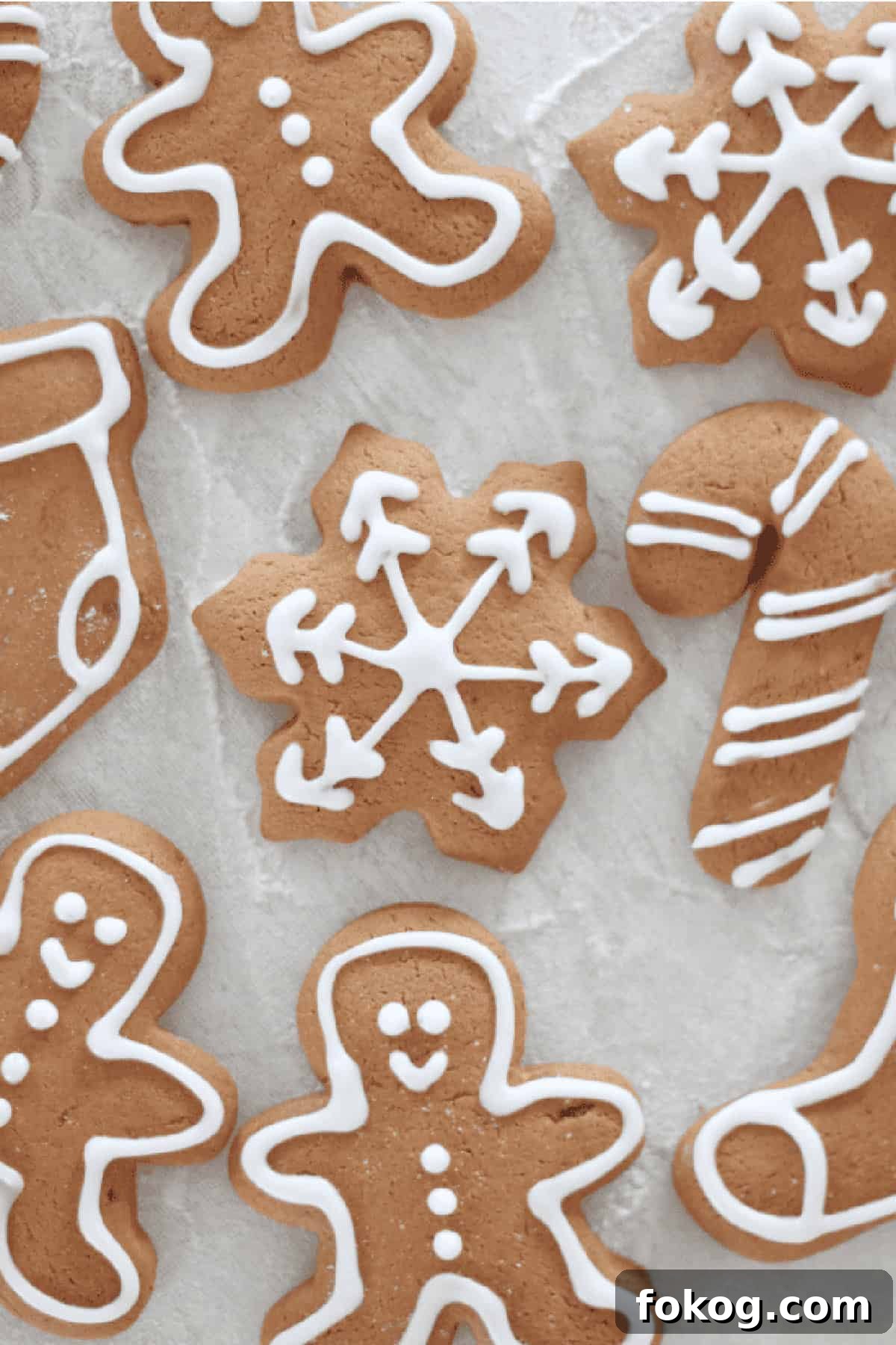 Cutout gingerbread cookeis iced with white outlines.