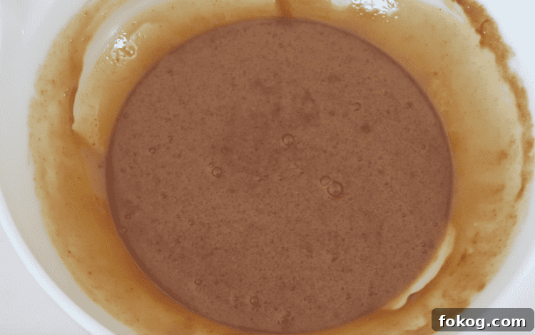 wet ingredients for gingerbread cookies in mixing bowl