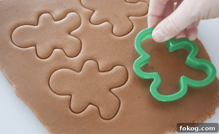 quick gingerbread cookie dough rolled out and cut out with cookie cutters