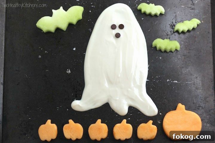 Ghostly Halloween Fruit Dip with cut-out fruit