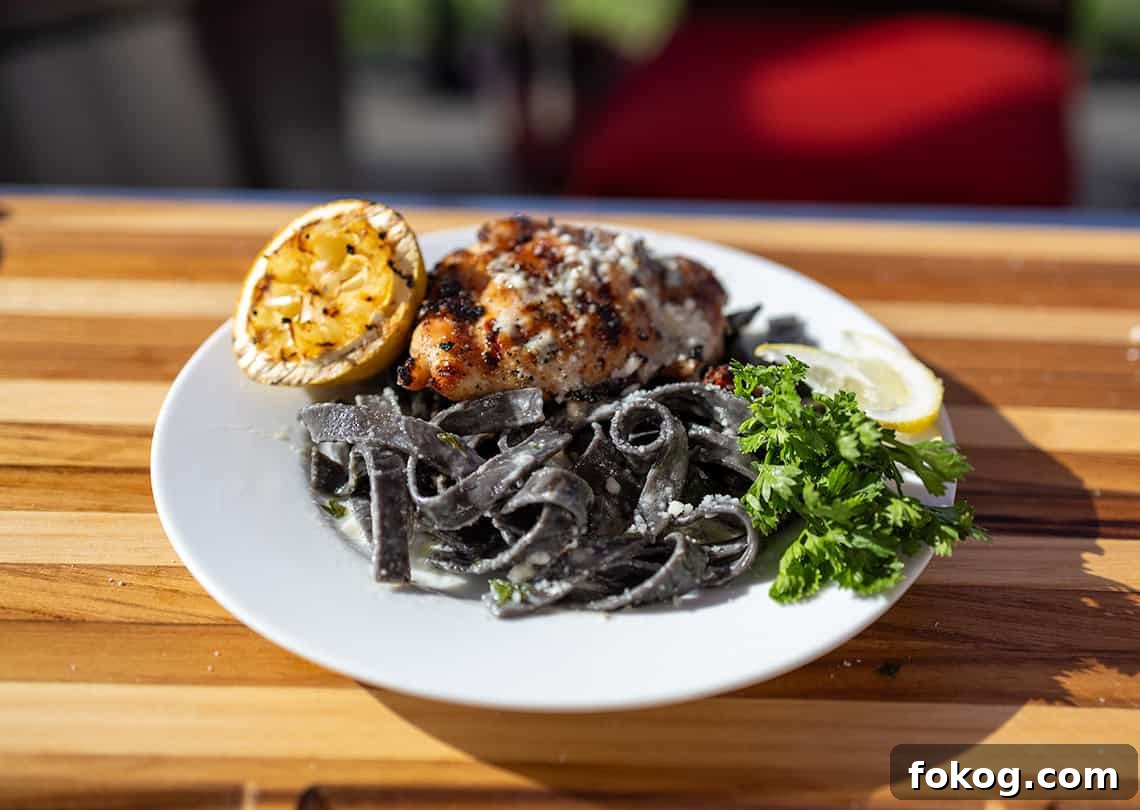 Lemon Garlic Cream Grilled Chicken Pasta Recipe 2 Grilled Chicken with squid ink pasta on a plate.