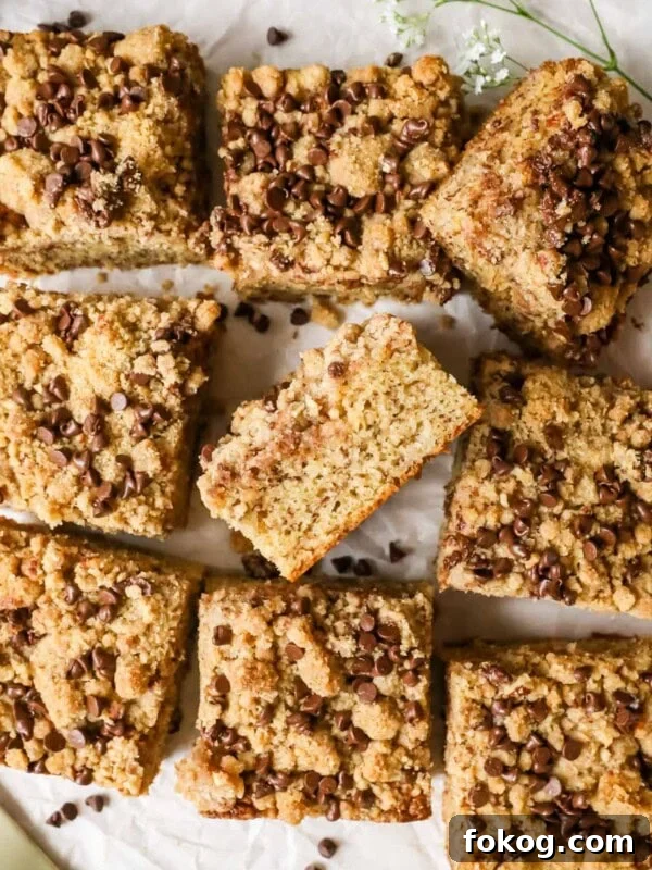 Overhead view of a banana coffee cake that's been removed from the pan and cut into square pieces.
