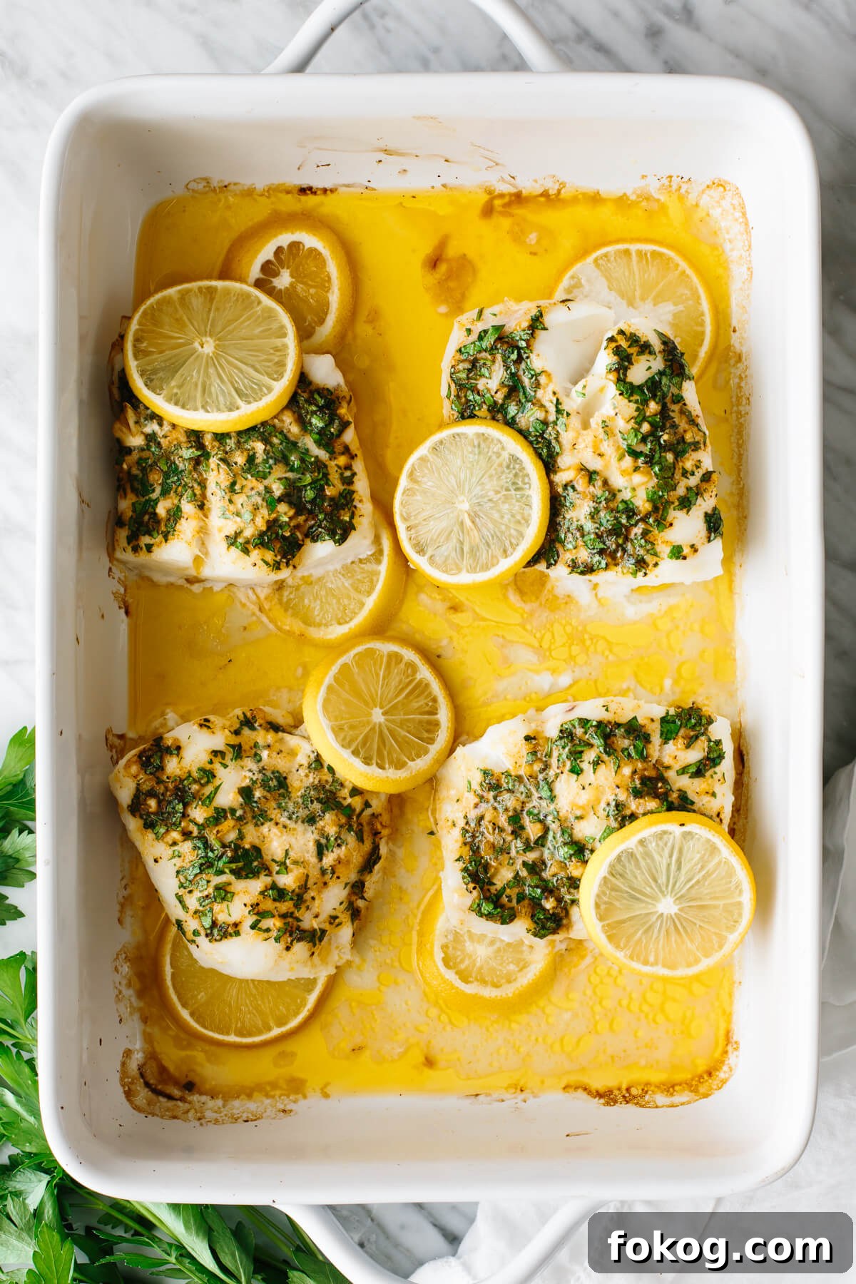 40+ Low-Carb Recipes for Weight Loss and Blood Sugar Control 2 Four baked cod filets in a white casserole dish.