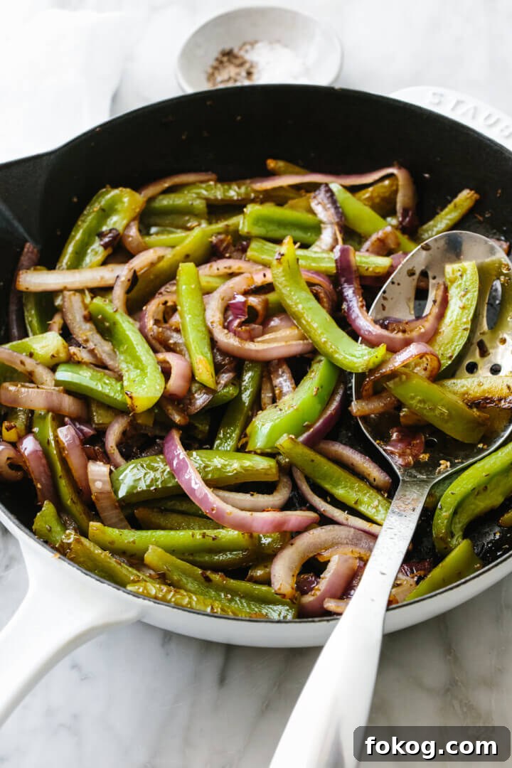 40+ Low-Carb Recipes for Weight Loss and Blood Sugar Control 11 Fajita veggies in a skillet with a slotted spoon.