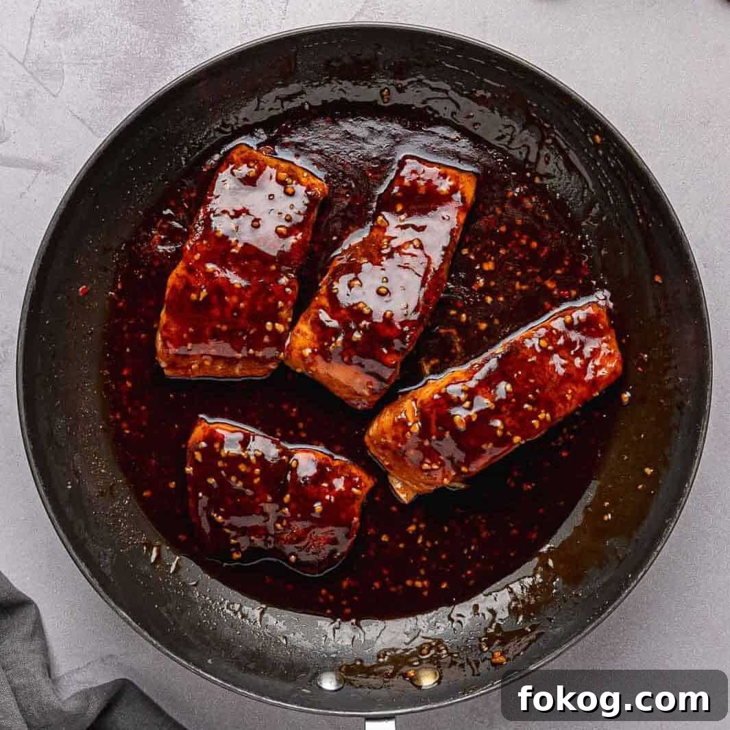 A glossy, thick honey garlic glaze coating the salmon fillets.