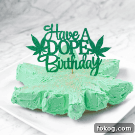A white countertop and a white plate with a green frosted cannabis cake with a topper that says have a dope birthday
