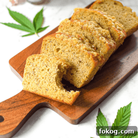 A photo of sliced cannabis banana bread on a cutting board with a cannabis leaf in the background