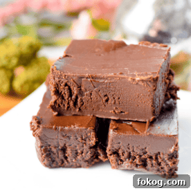 A white plate with stacked pieces of cannabis fudge.