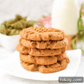 A white plate with a stack of cannabis peanut butter cookies