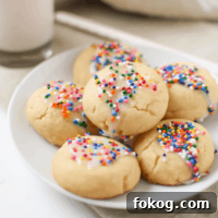 A picture of several Italian Spritz Cookies with Anise on a white plate.