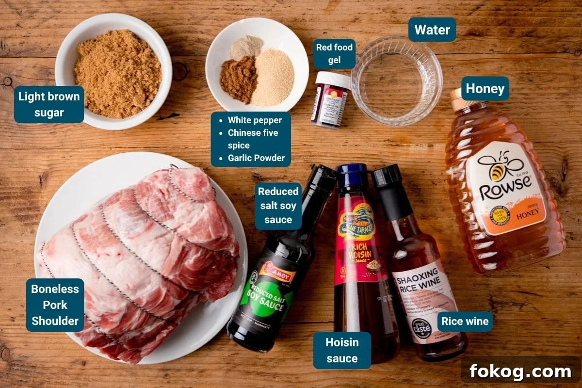 Ingredients for a char siu pork displayed on a wooden surface, including boneless pork shoulder, sauces, spices, sugar, water, honey, and red food colouring gel. Labels identify each item.