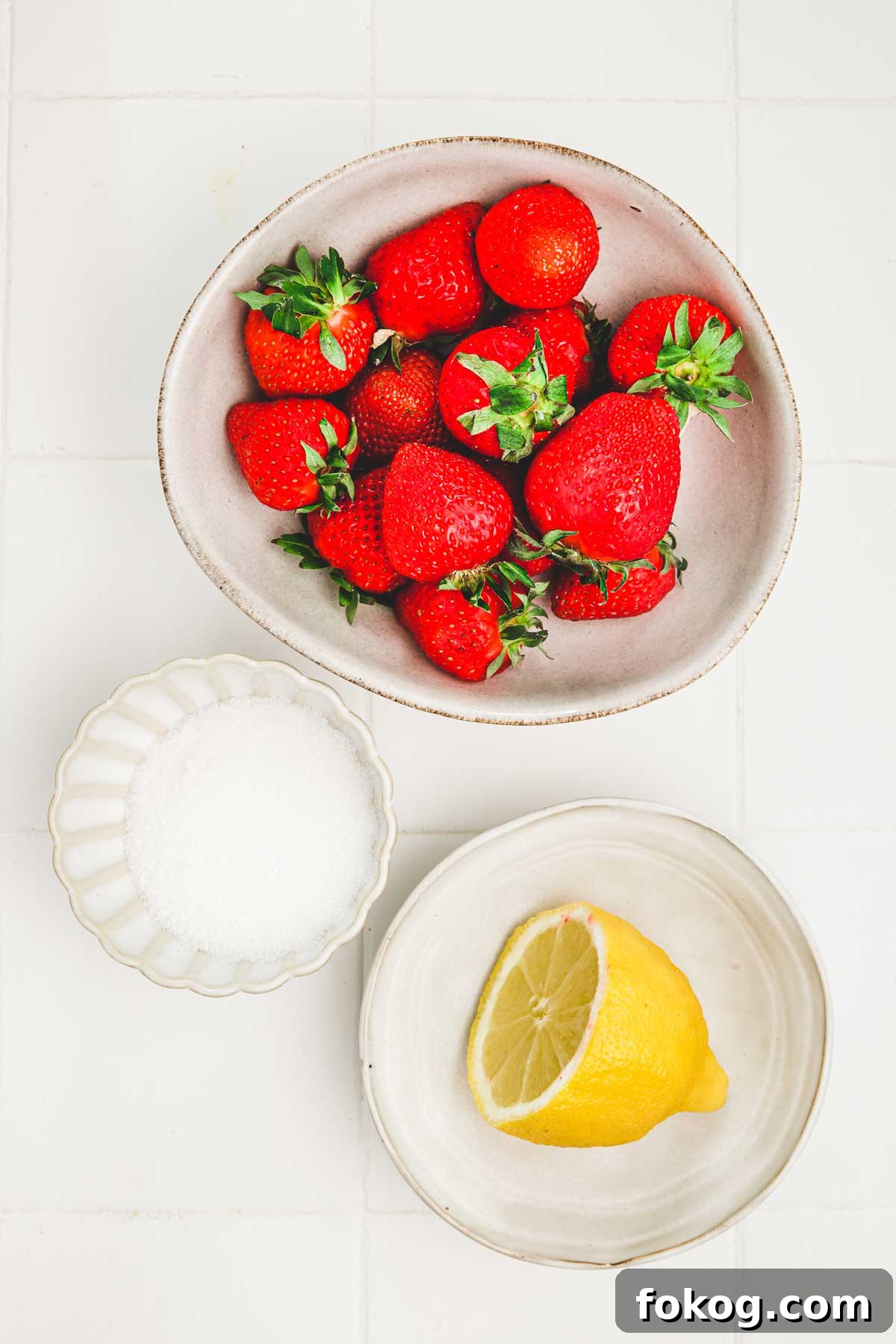ingredients for strawberry puree: chopped strawberries, lemon juice and sugar in a bowl