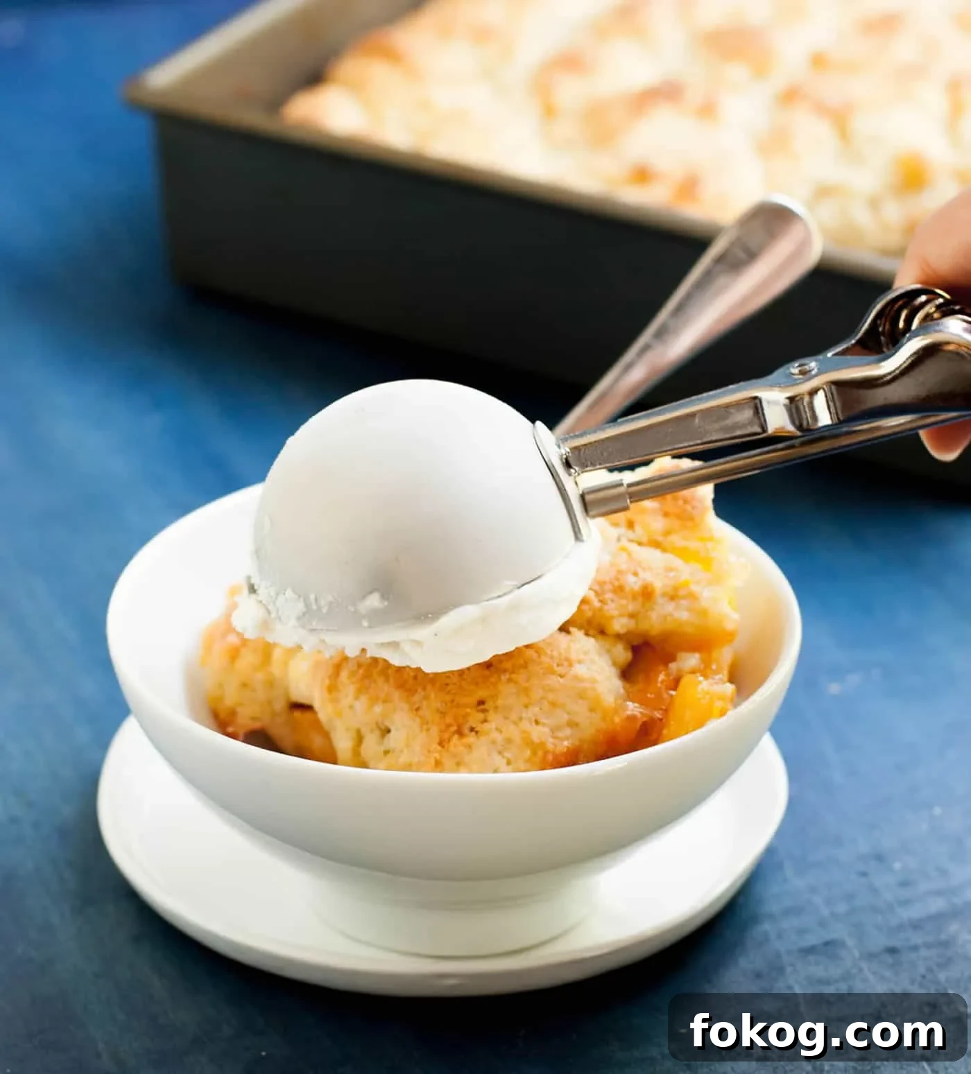 Georgia Peach Cobbler. Fresh peaches, lightly spiced and sweetened with two kinds of sugar, are baked under a delicious sweet biscuit topping!