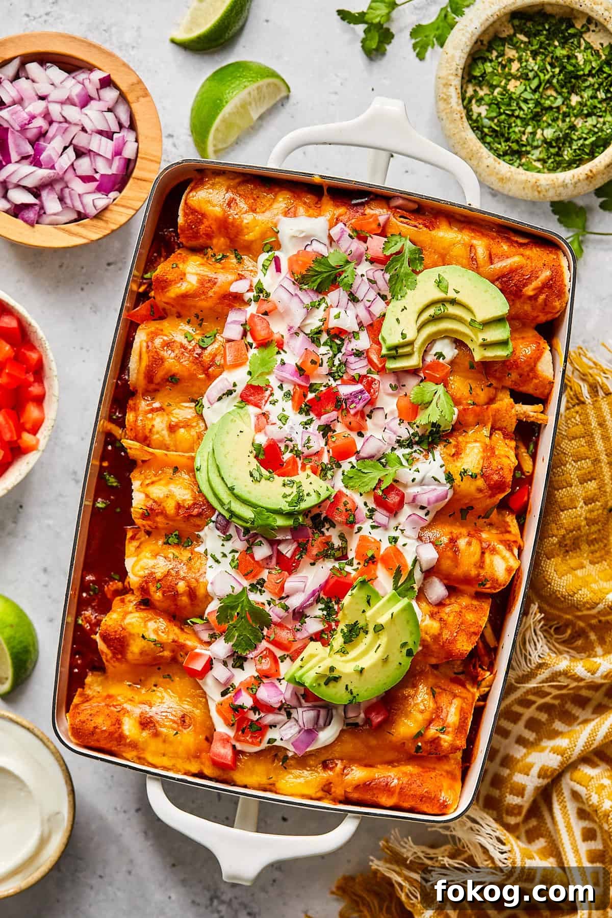 Chicken and Black Bean Enchiladas with Tangy Salsa Verde 10 Chicken and black bean enchiladas with toppings in a casserole dish