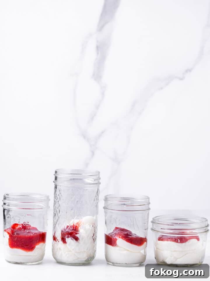 Creamy Raspberry Parfait Recipe with Crunchy Granola 5 raspberry jam added to plain greek yogurt in jars