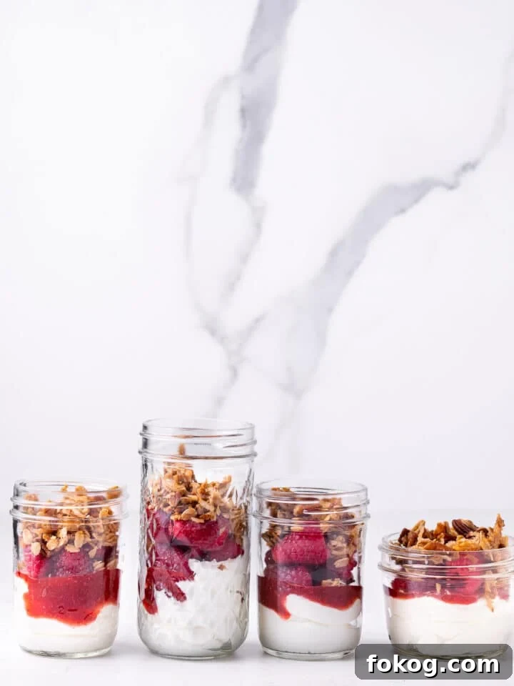Creamy Raspberry Parfait Recipe with Crunchy Granola 7 four jars with raspberry parfait topped with granola