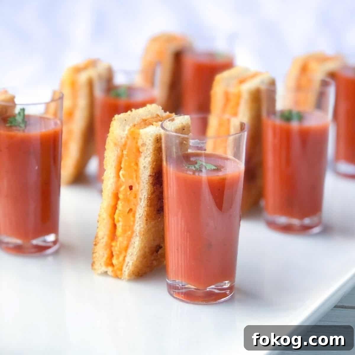 Baked grilled cheese sticks with tomato soup shooter.