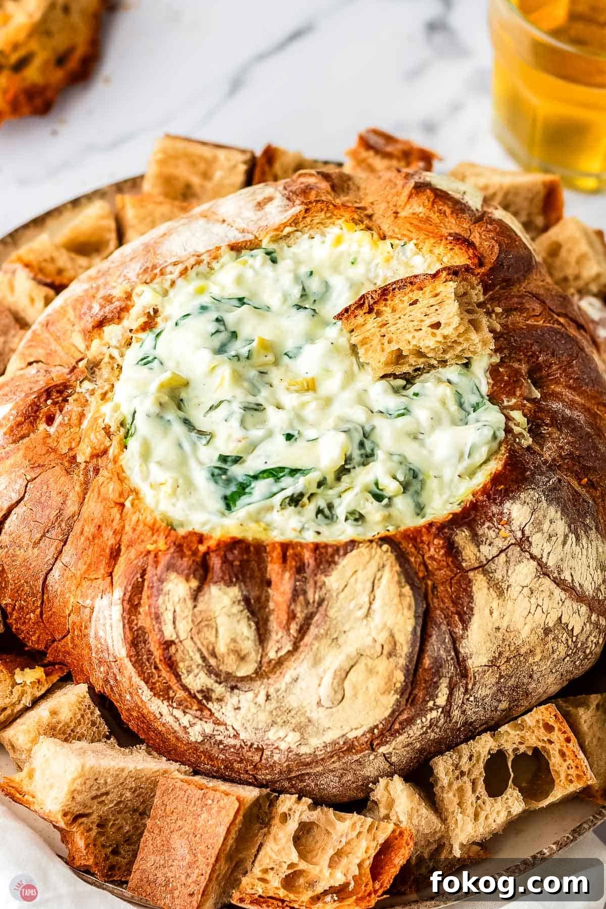 spinach artichoke dip in a bread bowl
