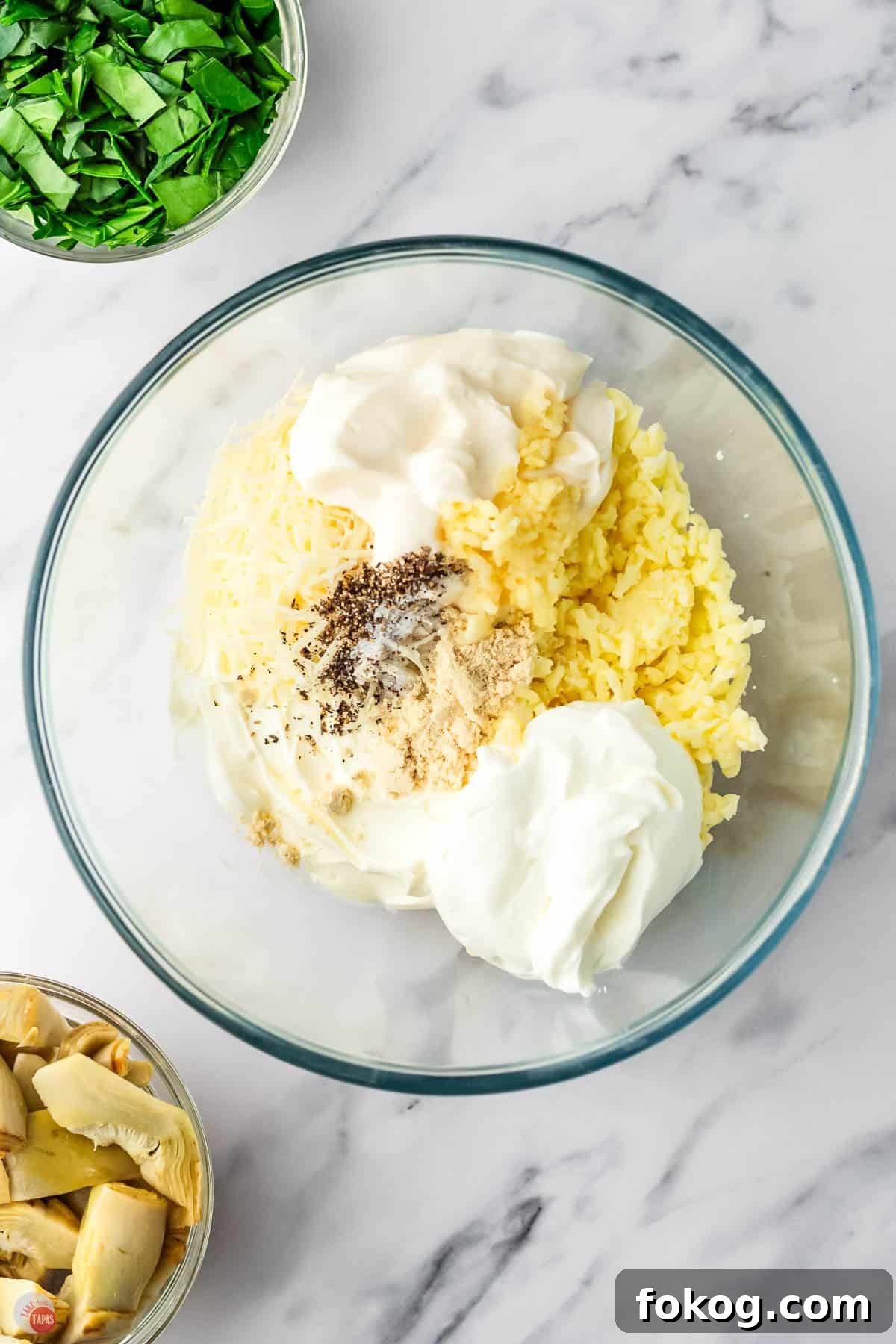 mayonnaise, cream cheese, and spices in a clear bowl