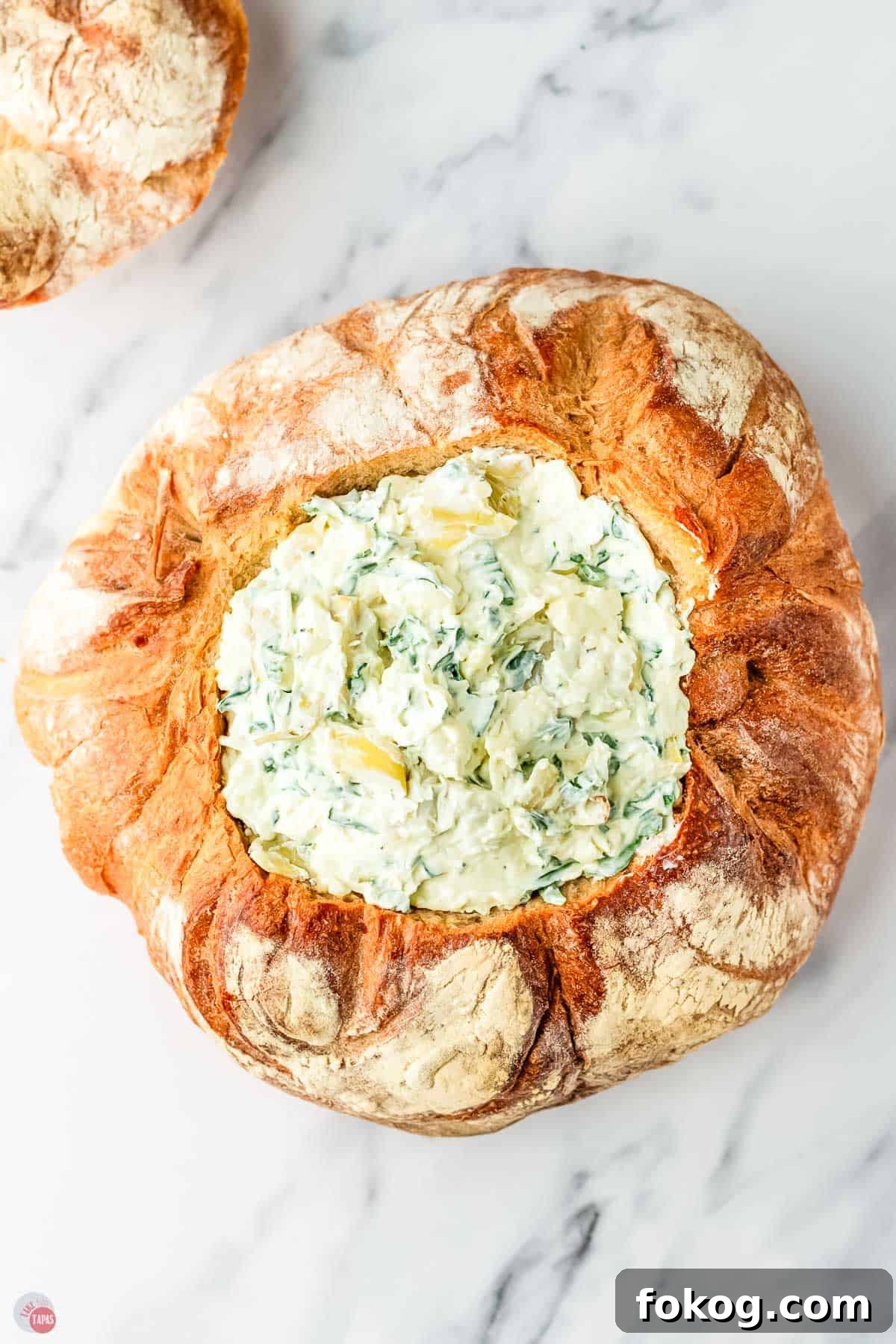 spinach artichoke dip in a bread bowl