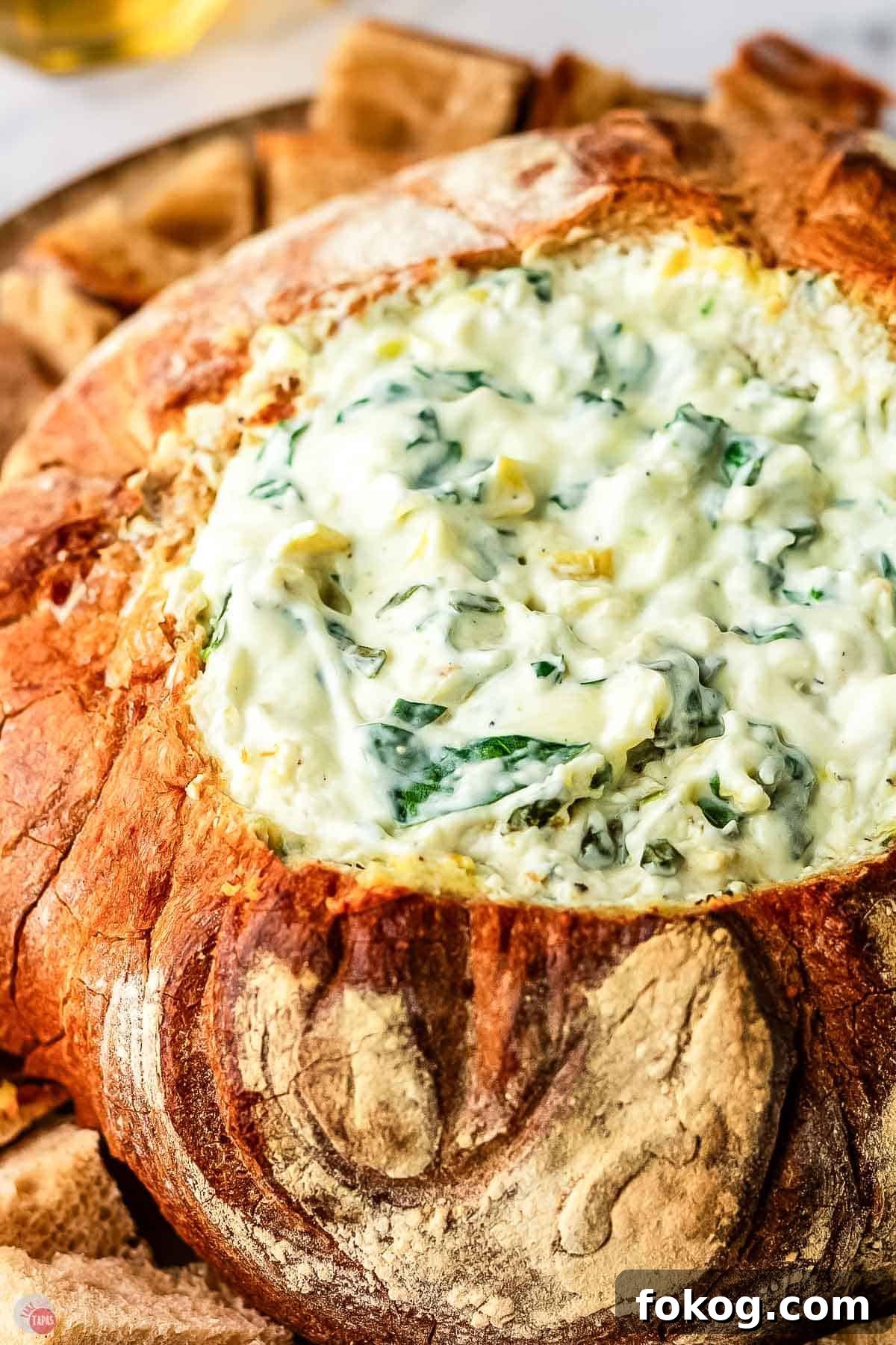 spinach artichoke dip baked in a bread loaf
