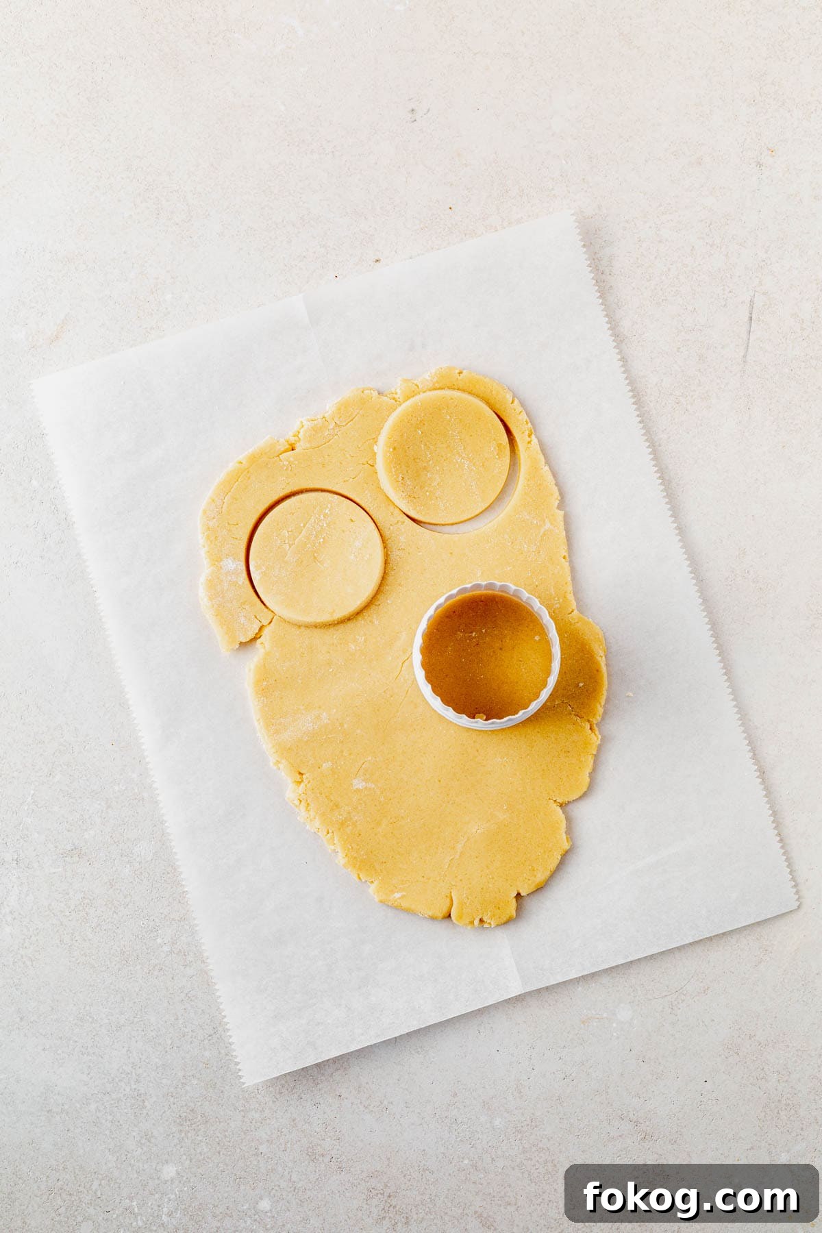 Millionaire Cookie Recipe: Caramel Shortbread Bars Tutorial 5 shortbread cookie dough rolled out on a counter with a circle cookie cutter on top.