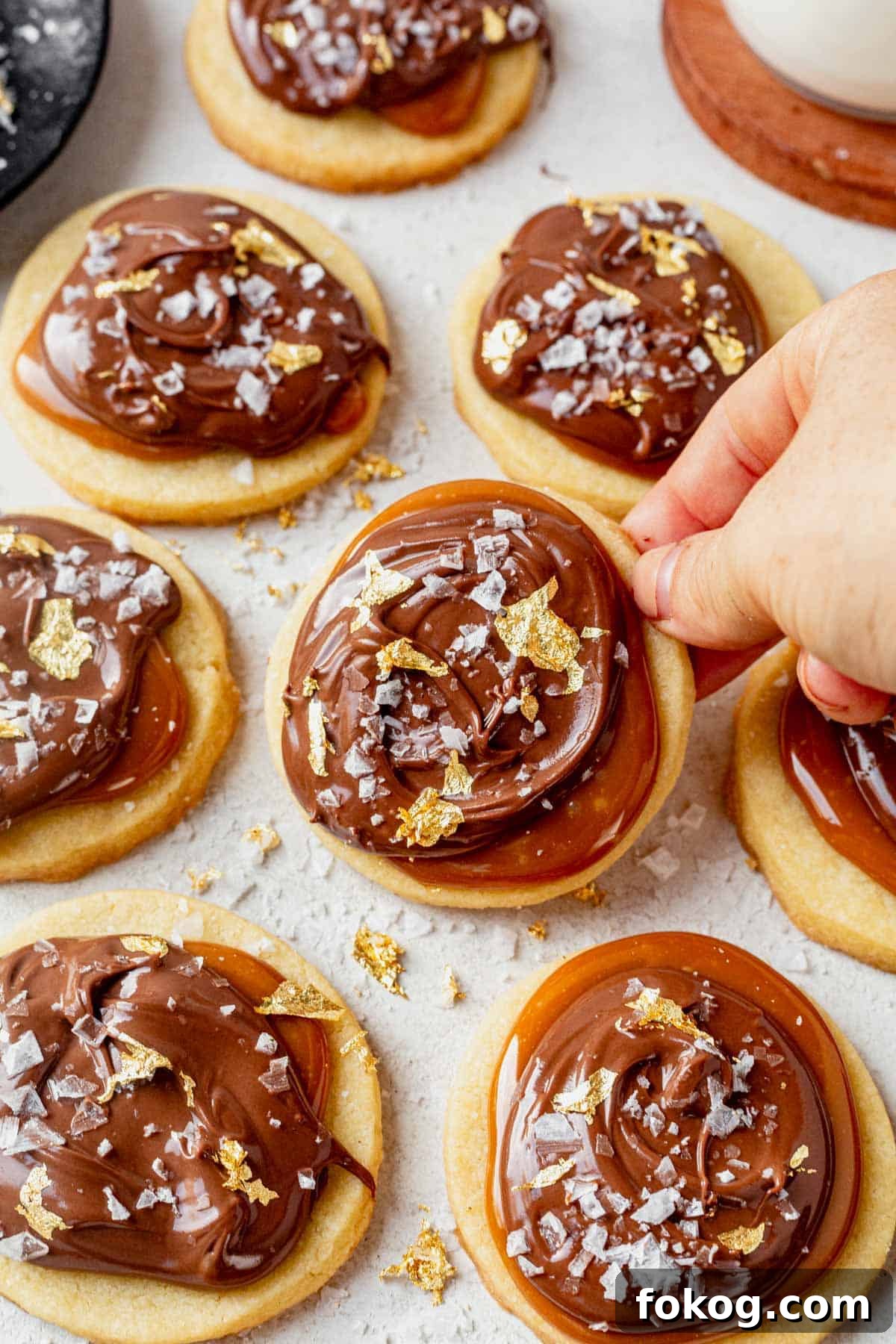 Millionaire Cookie Recipe: Caramel Shortbread Bars Tutorial 10 picking up a millionaire cookie from a countertop.