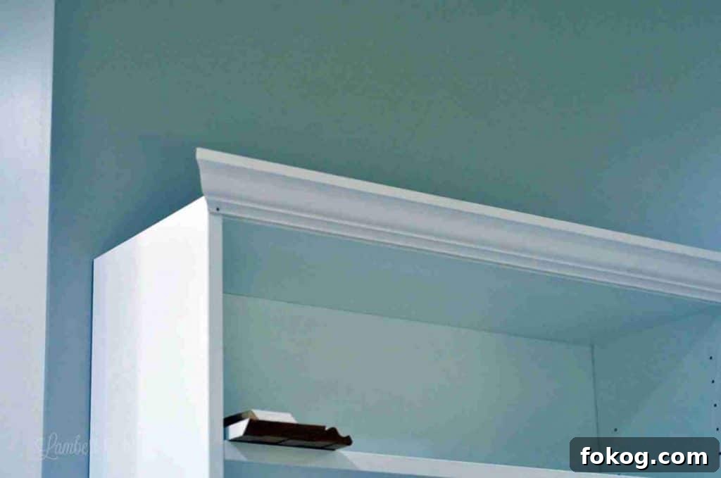 Built-In Bedroom Wardrobe Using IKEA Billy Bookcases 15 front piece of crown molding nailed in.