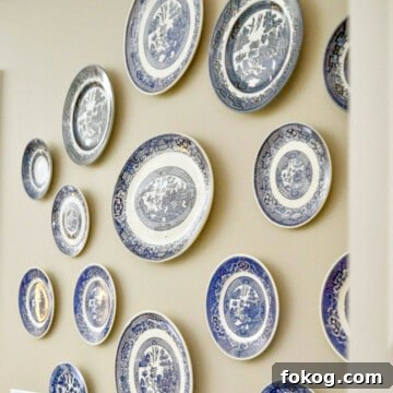 blue and white plates hanging on a wall.