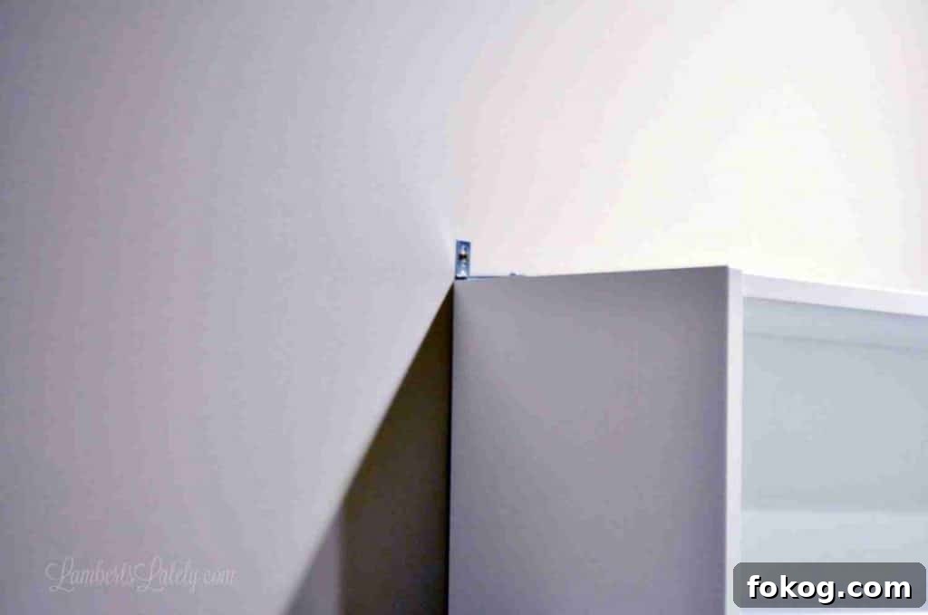 Built-In Bedroom Wardrobe Using IKEA Billy Bookcases 10 metal brace installed on top of cabinet.