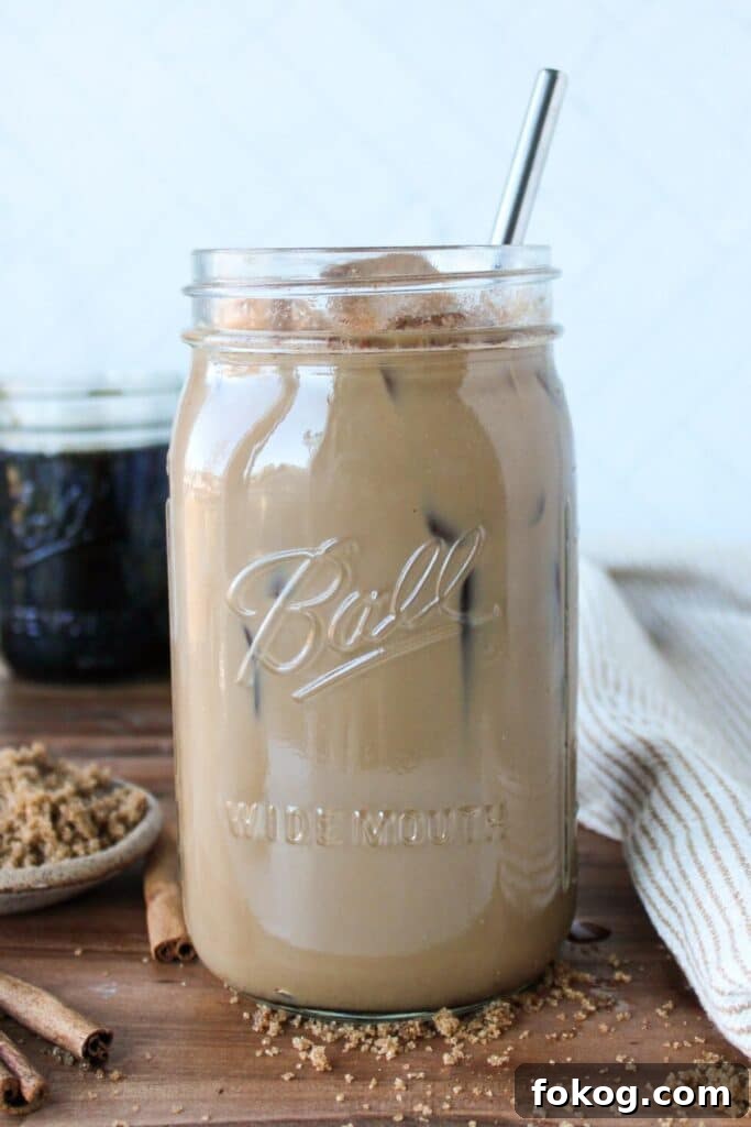 Iced Brown Sugar Latte Recipe — Creamy Cold Coffee Drink 2 A large mason jar full of brown sugar coffee and ice.